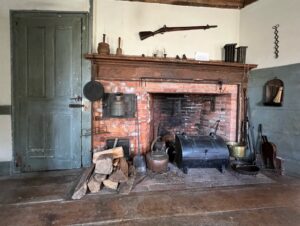 Keeping room - fireplace with rifle and powder horn over mantle