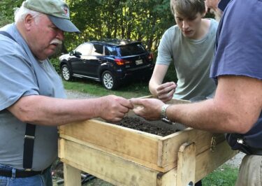 3 men at archaeology dig